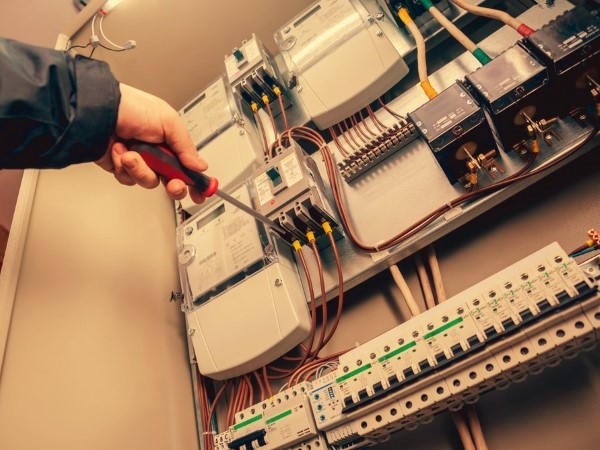 An electrician fitting a light bulb